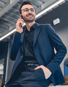 smiling-business-man-making-call-by-mobile-QTFFSUA-1.jpg